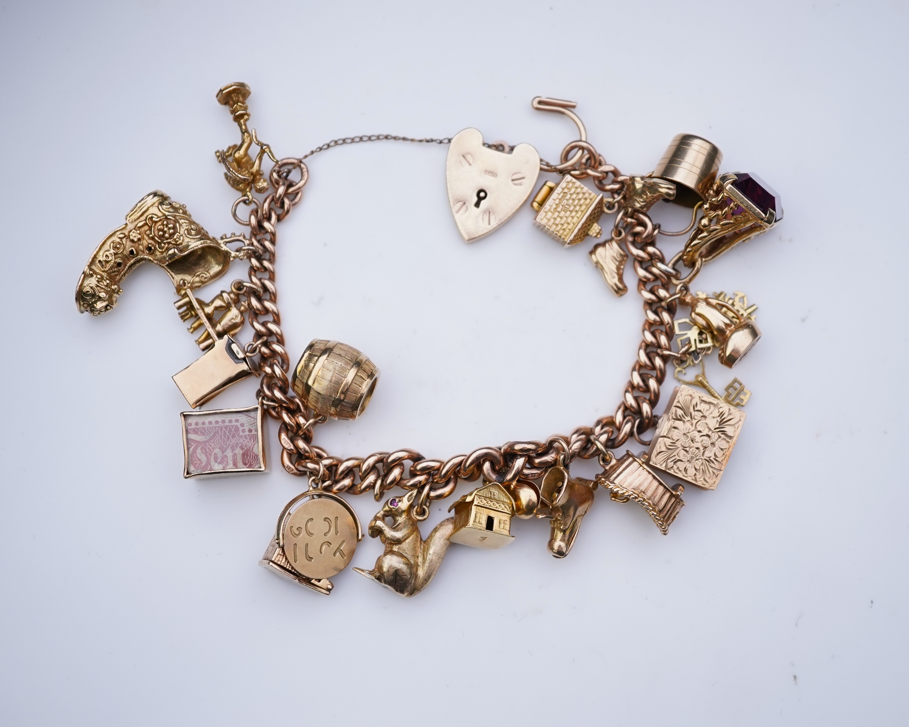 A 9ct gold charm bracelet, mid 20th century